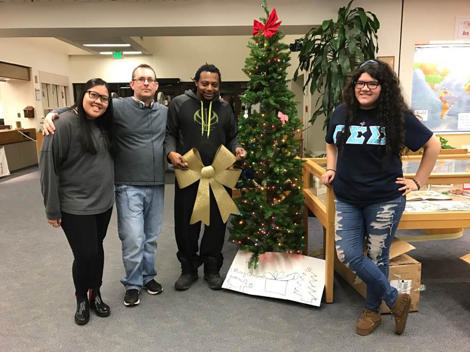 Dr. Sabol with students decorating the school library for the holidays