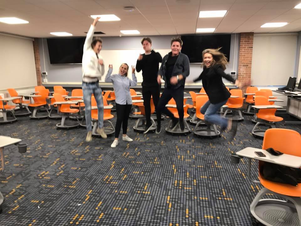 Students and faculty celebrating in a modern classroom